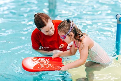 Swim school teacher with student