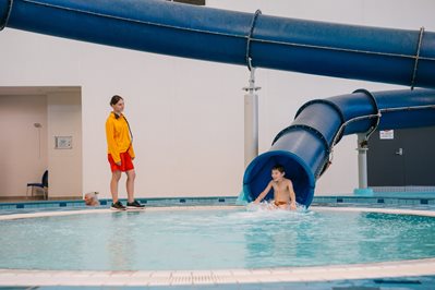 Waterslide with child and lifeguard